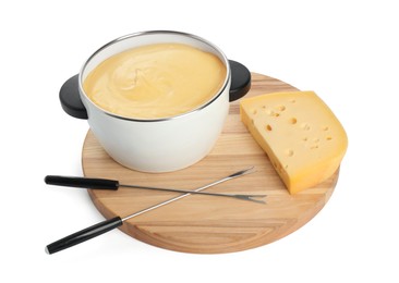 Photo of Fondue with tasty melted cheese, forks and piece isolated on white