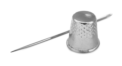 Sewing thimble and needle isolated on white