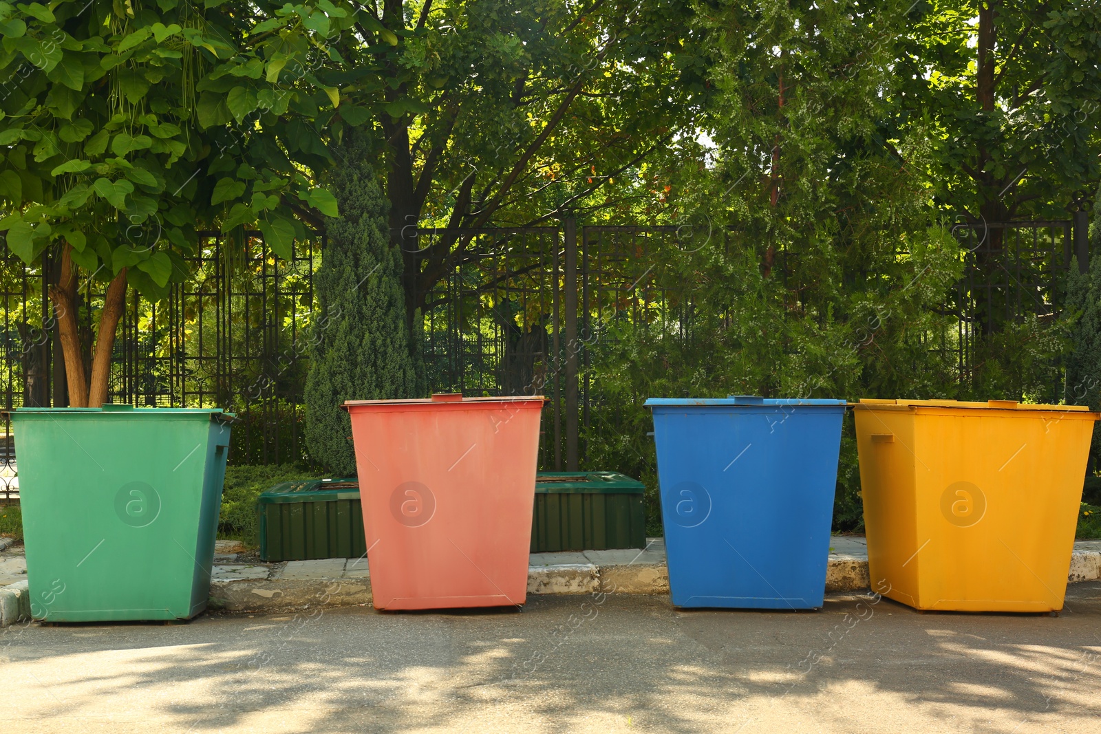 Photo of Recycling bins for different types of garbage outdoors