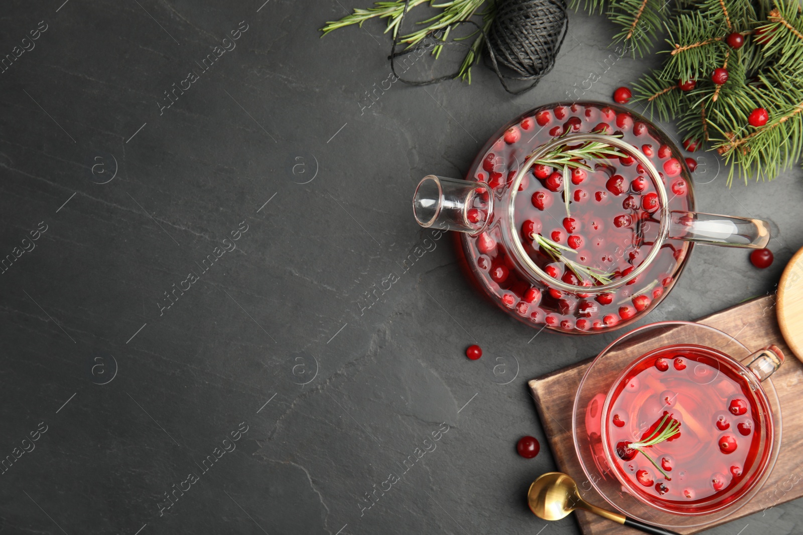 Photo of Flat lay composition with tasty hot cranberry tea on black table. Space for text