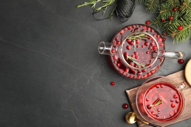 Photo of Flat lay composition with tasty hot cranberry tea on black table. Space for text