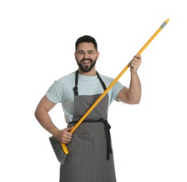 Young man with yellow broom on white background