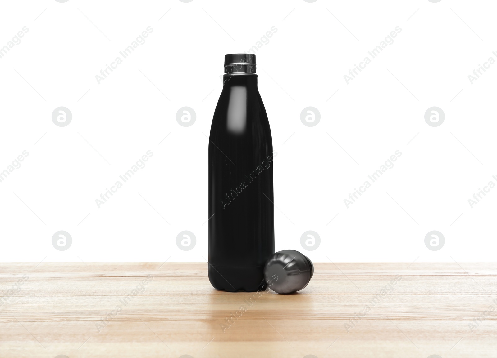 Photo of Stylish thermo bottle on wooden table against white background