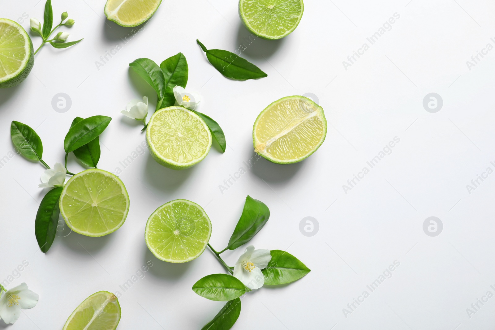 Photo of Composition with fresh ripe limes on white background, top view