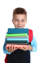 Happy boy in school uniform with stack of books on white background