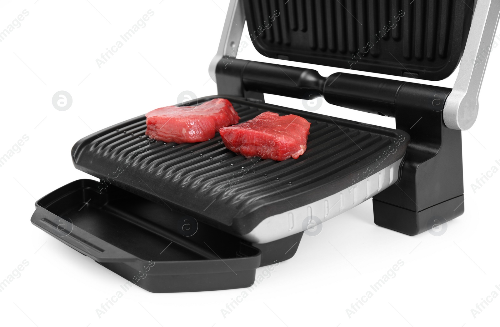 Photo of Electric grill with raw meat steaks isolated on white