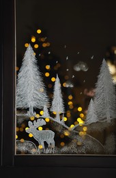 Photo of Beautiful drawing made with artificial snow on window. Christmas decor