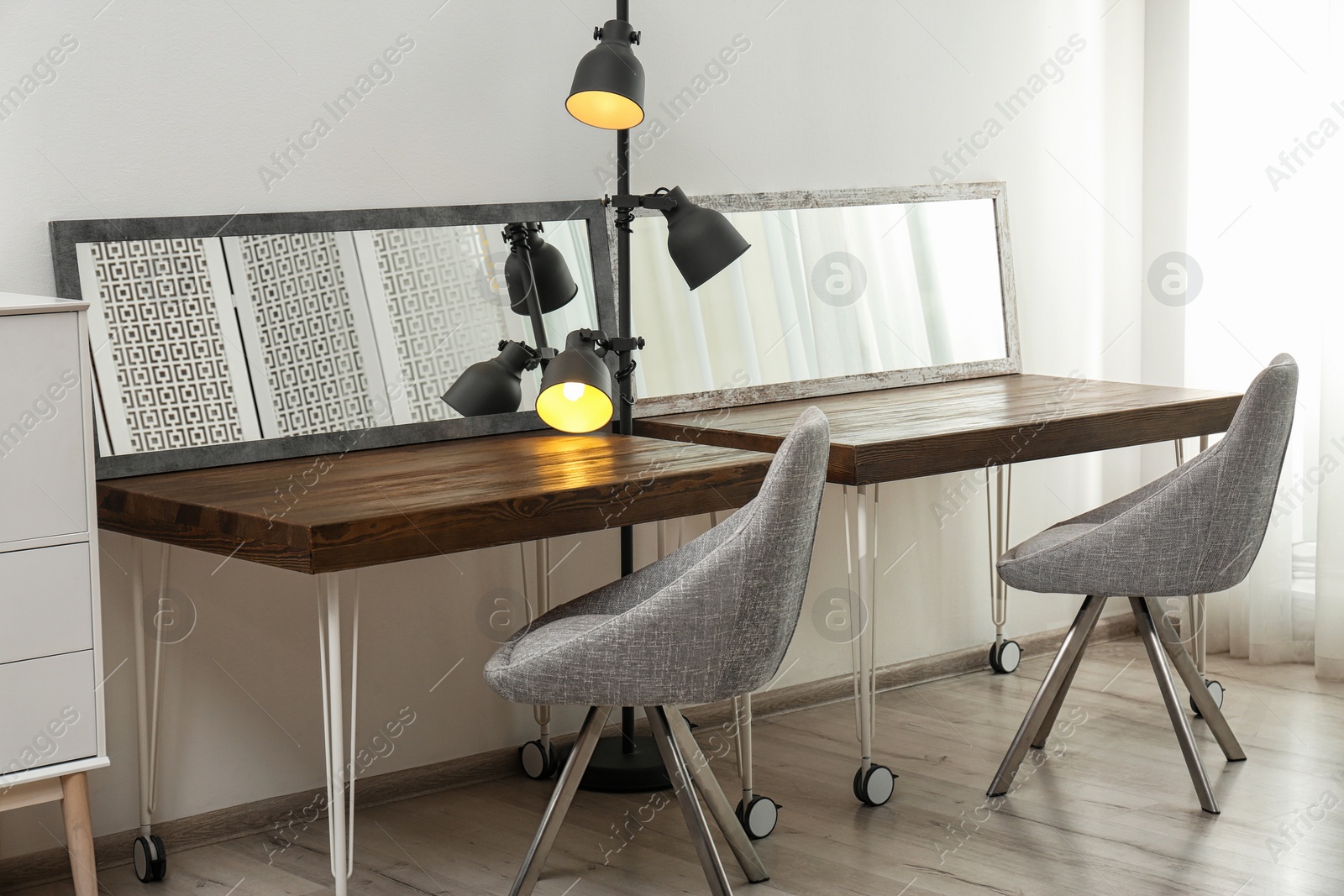 Photo of Empty dressing tables with mirrors in makeup room