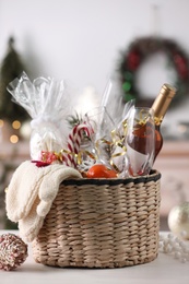 Photo of Wicker basket with Christmas gift set on white table