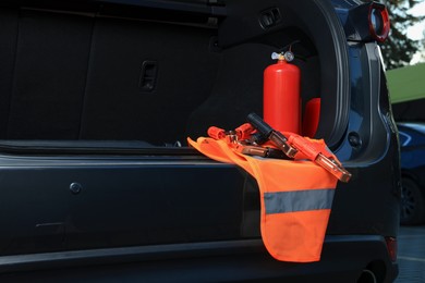 Set of car safety equipment in trunk, space for text