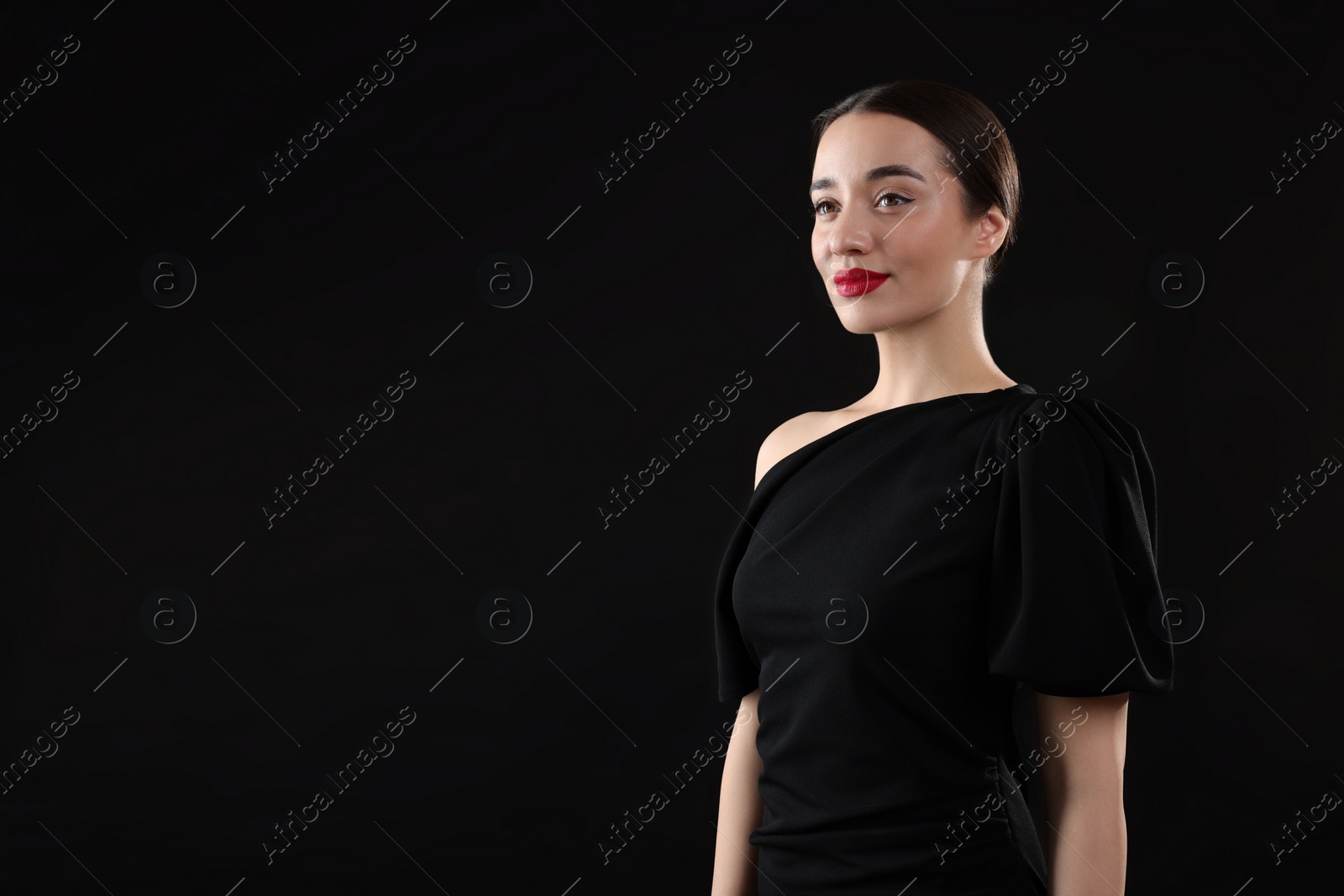 Photo of Beautiful young woman on black background, space for text