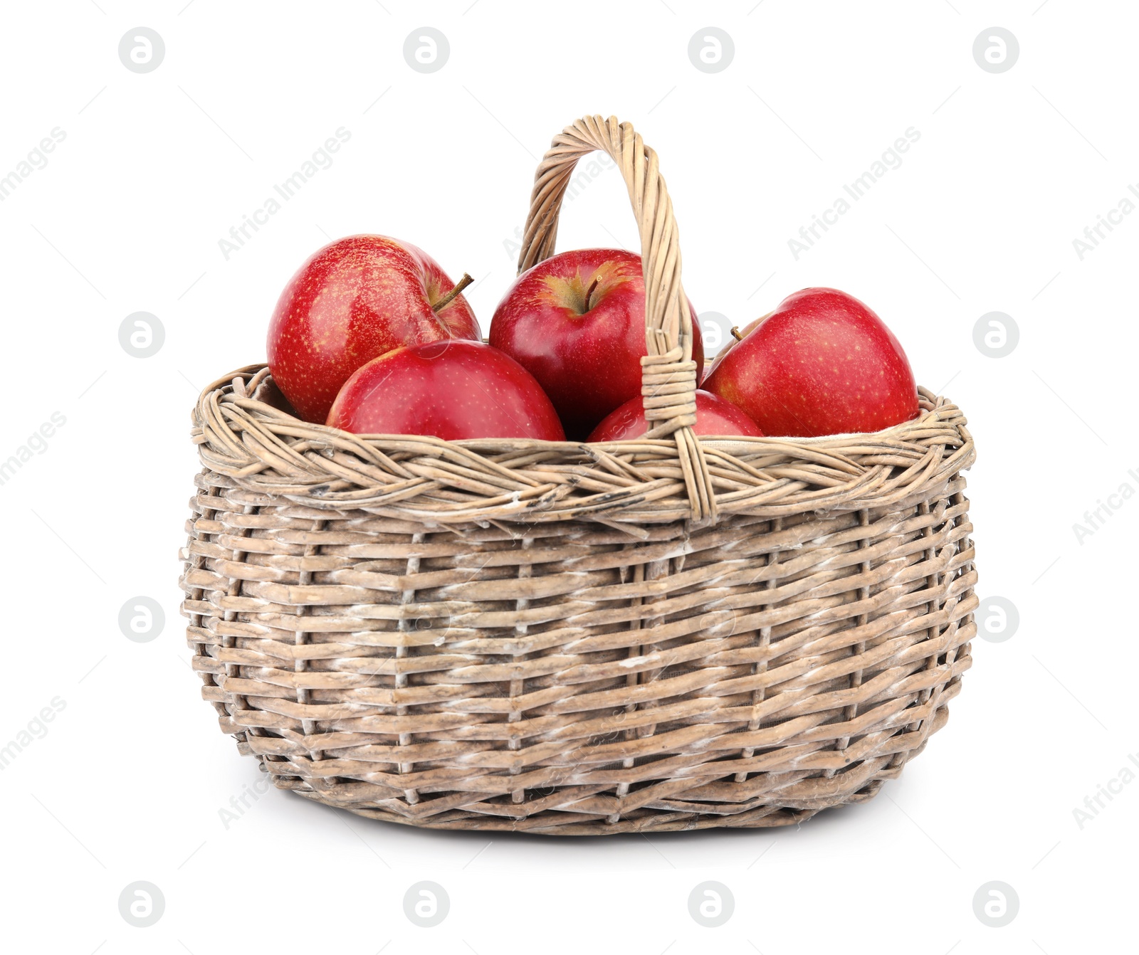 Photo of Wicker basket of ripe juicy red apples on white background