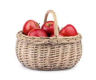 Photo of Wicker basket of ripe juicy red apples on white background