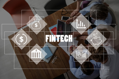 Image of Fintech concept. Business people working at table in office, top view
