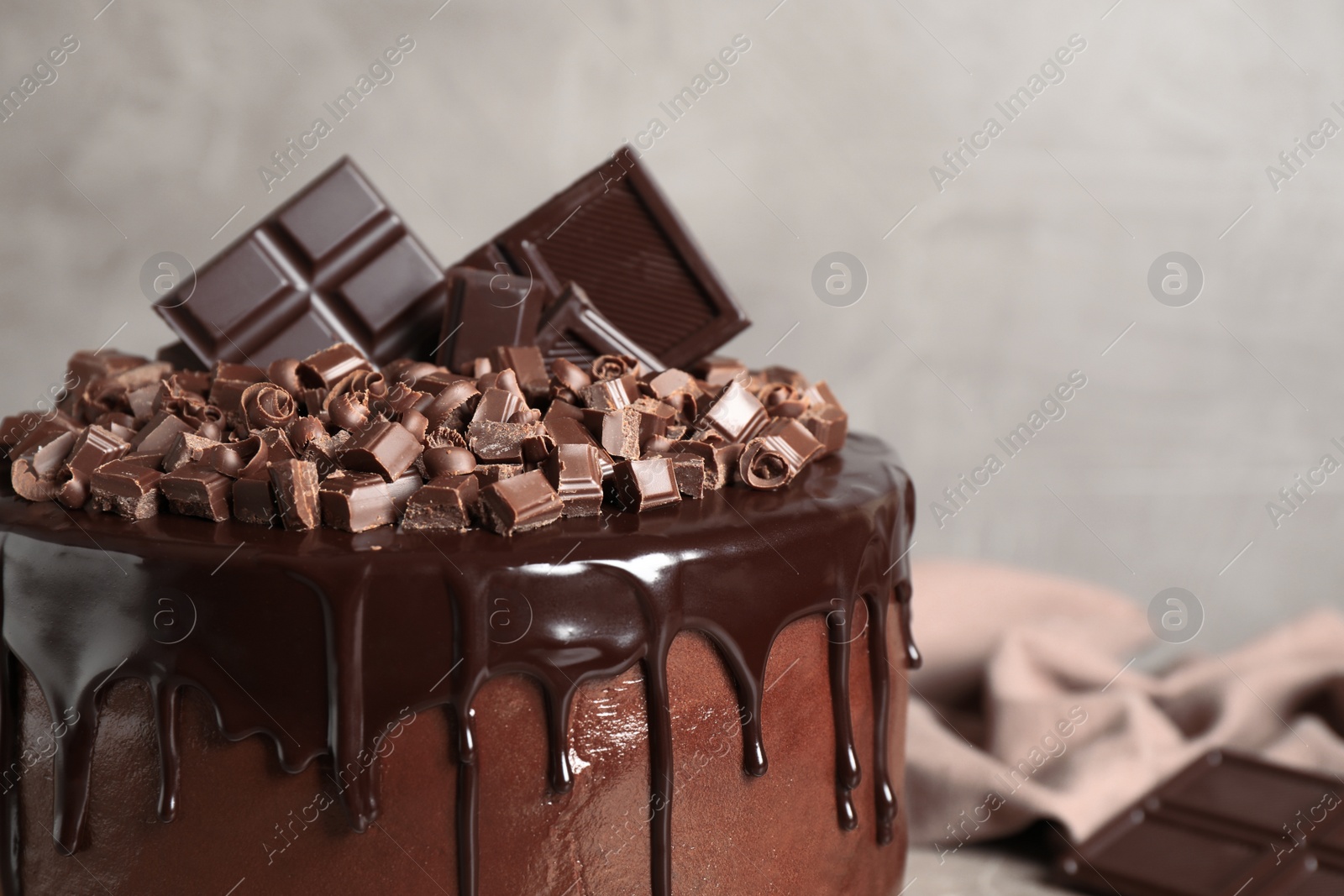 Photo of Freshly made delicious chocolate cake against grey background, closeup