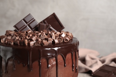 Photo of Freshly made delicious chocolate cake against grey background, closeup