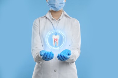 Image of Dentist showing virtual model of tooth on light blue background, closeup
