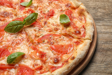 Delicious pizza Margherita on wooden table, closeup view