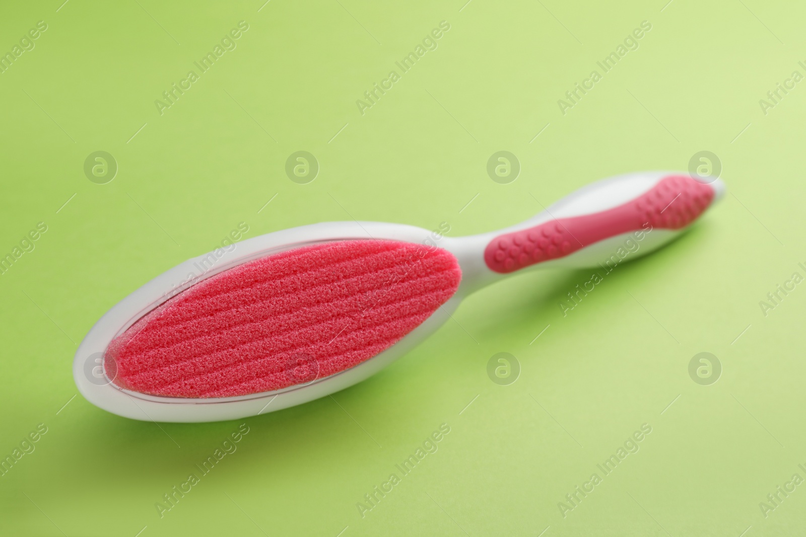 Photo of Pumice stone on green background. Pedicure tool