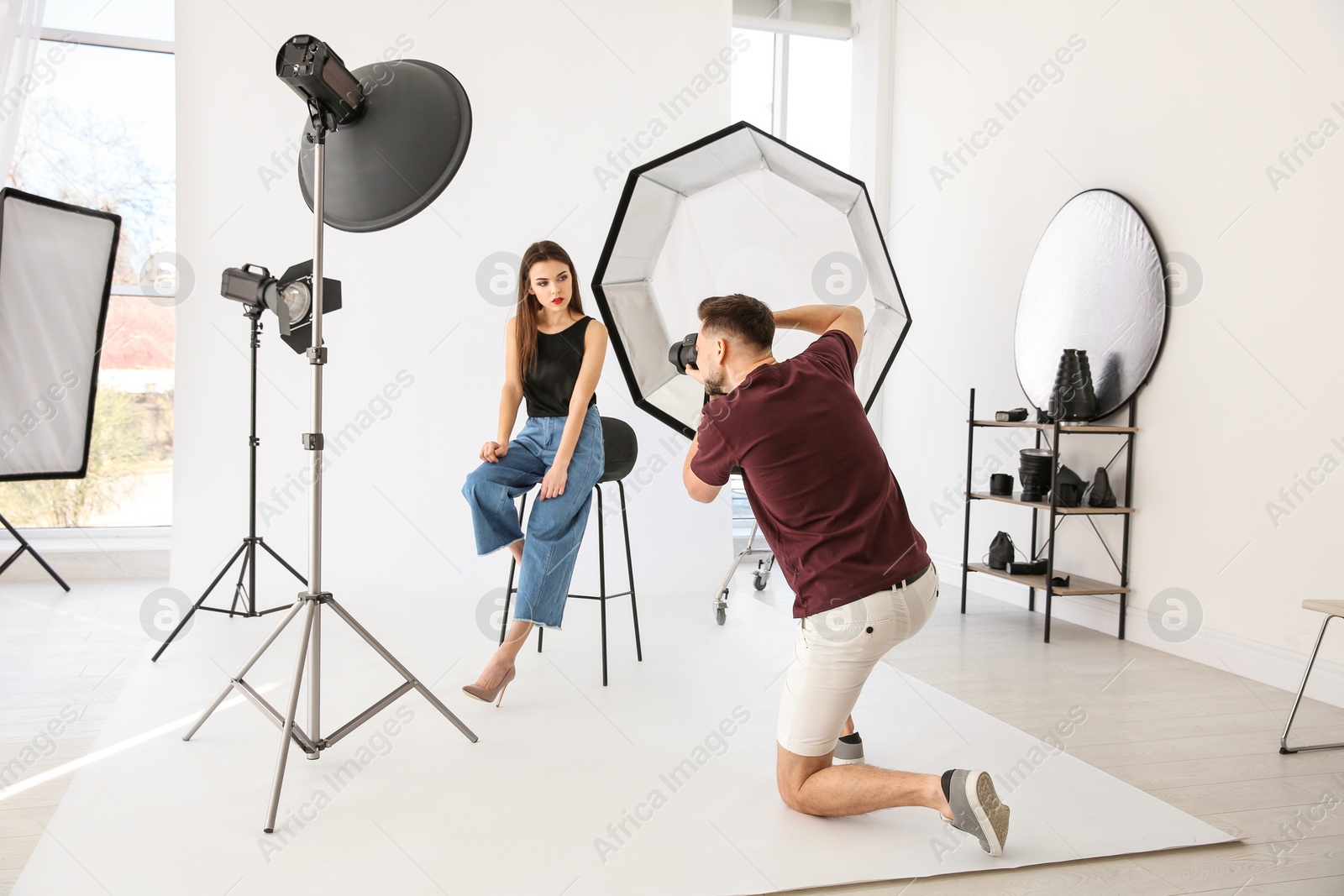 Photo of Beautiful young model posing for professional photographer in studio