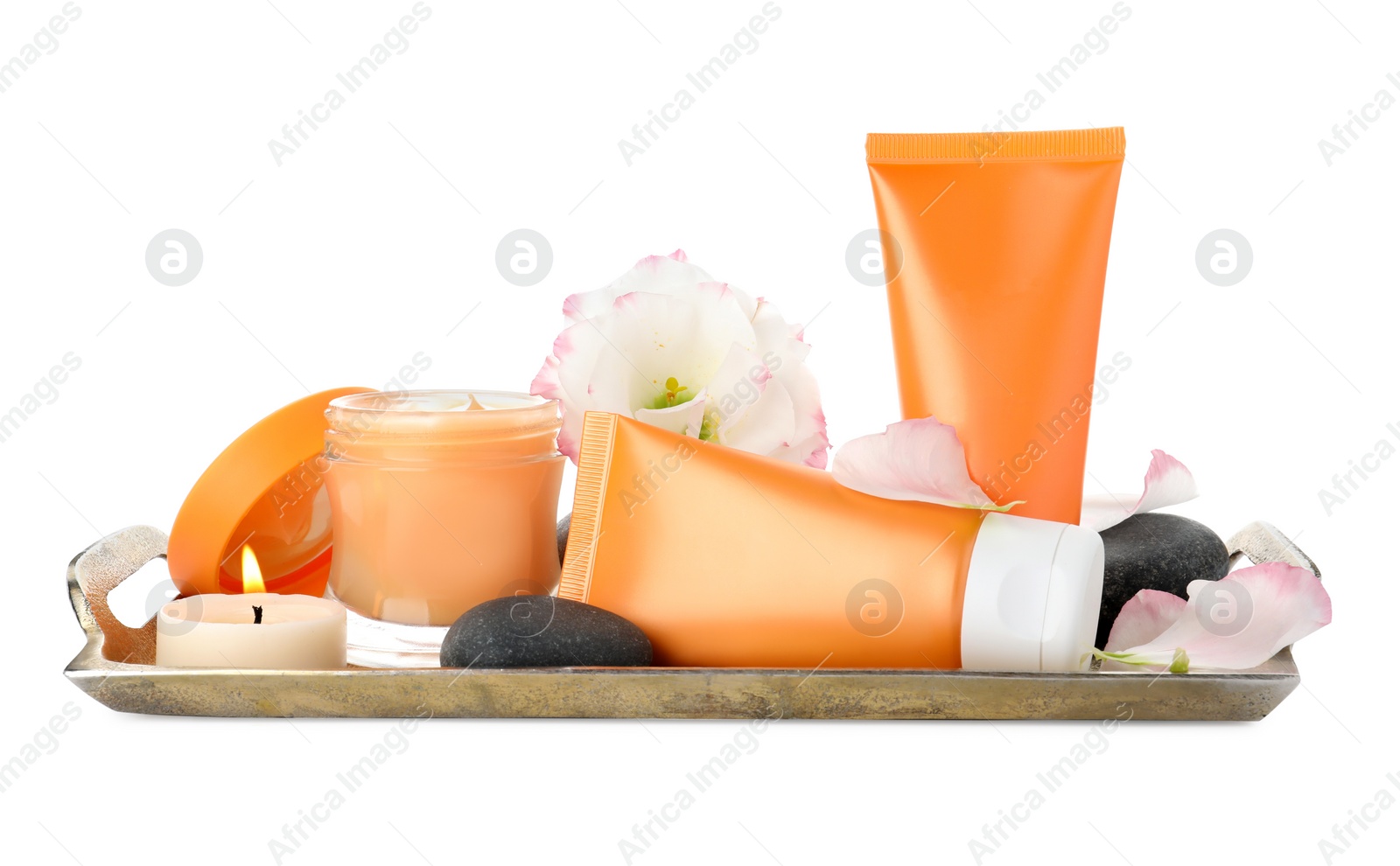 Photo of Tray with cosmetic products, flower and candle on white background