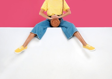 Woman wearing stylish shoes on color background, closeup