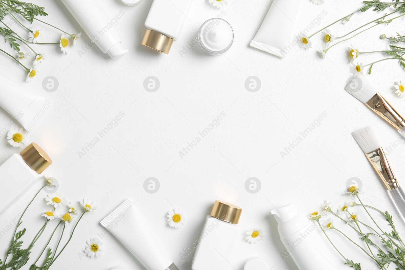 Photo of Flat lay composition with different cosmetic products, beauty accessories and chamomile flowers on white table. Space for text