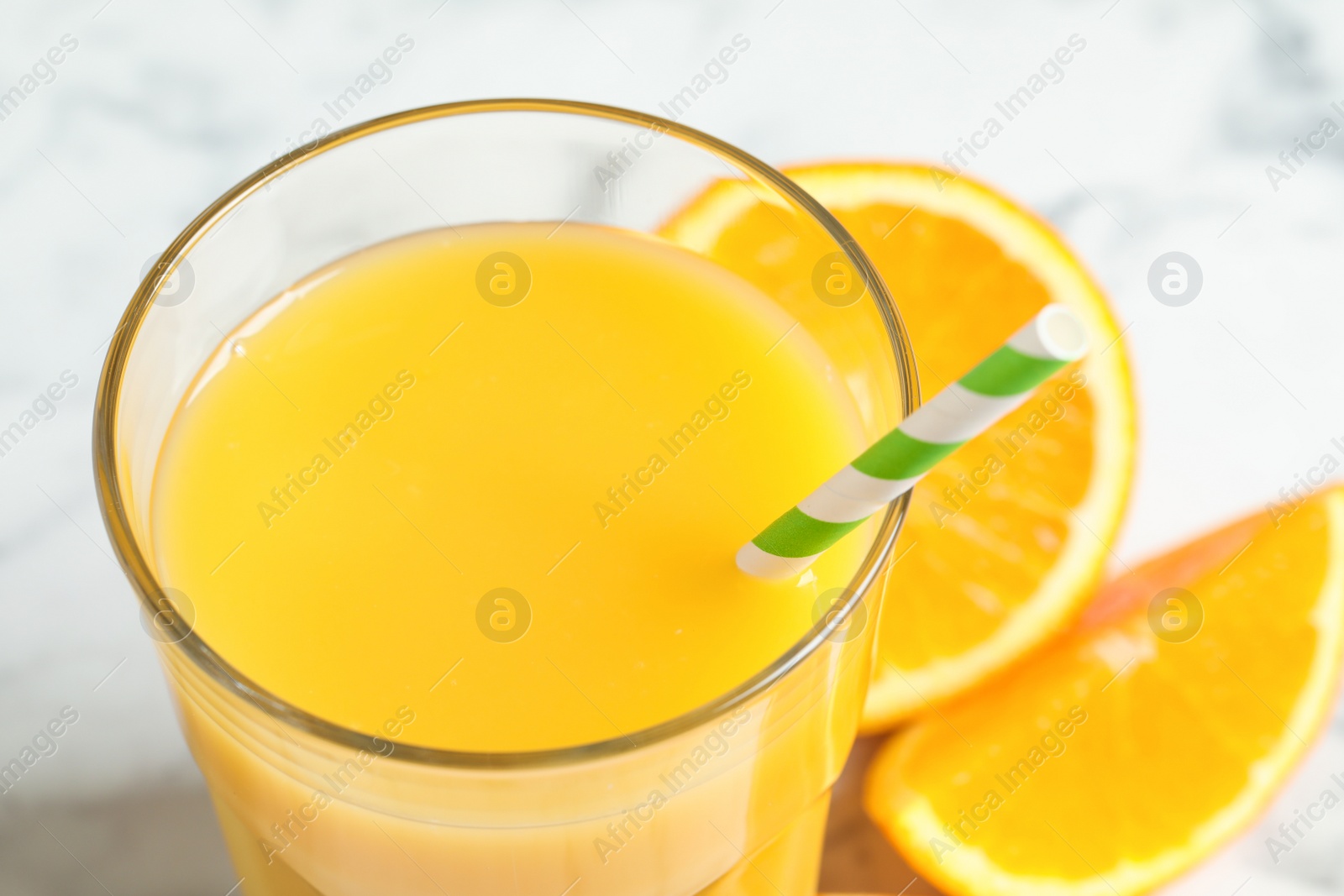 Photo of Glass of delicious fresh orange juice, closeup