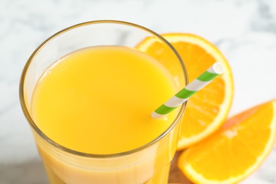 Photo of Glass of delicious fresh orange juice, closeup