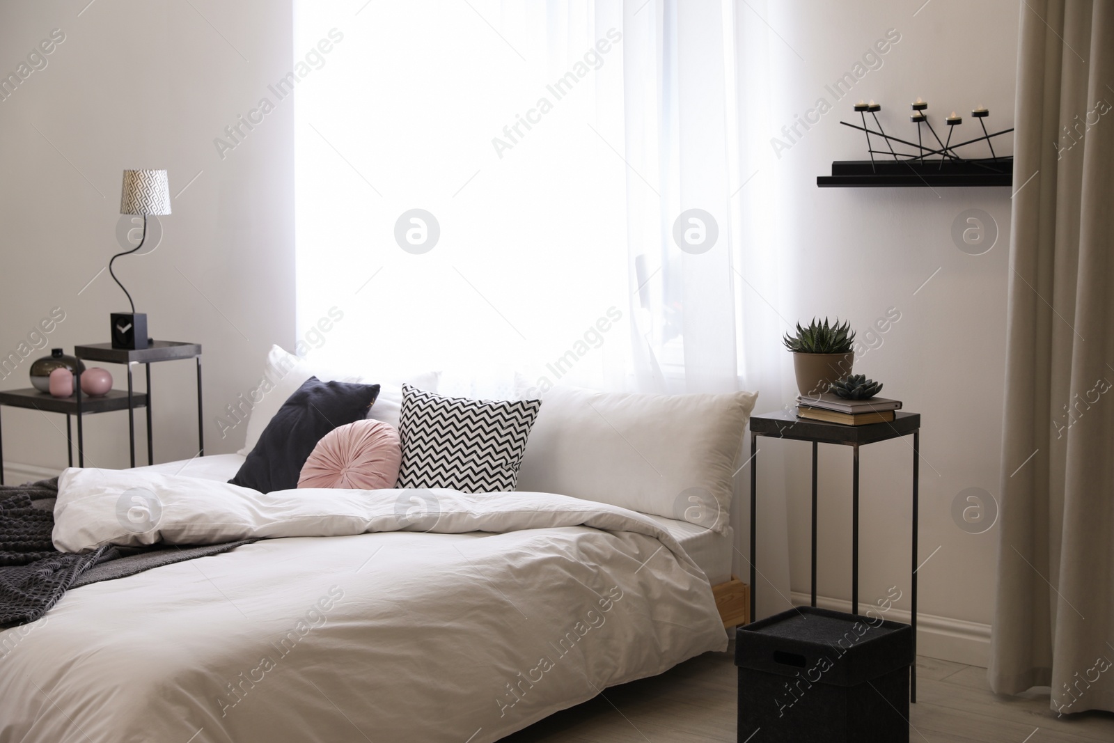 Photo of Stylish room interior with big comfortable bed