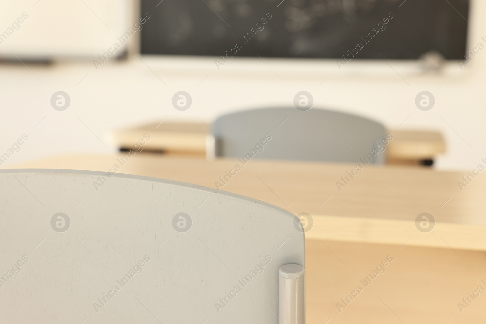 Photo of Empty school classroom with desks and chairs