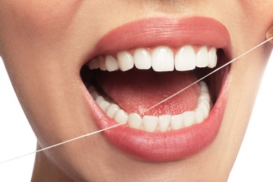 Photo of Woman flossing his teeth on white background, closeup. Dental care