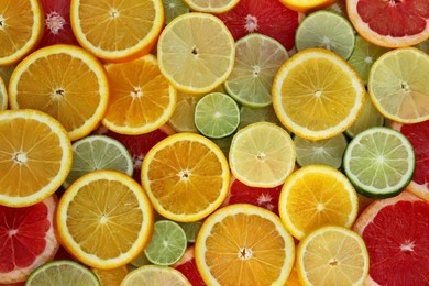 Photo of Different citrus fruits as background, top view