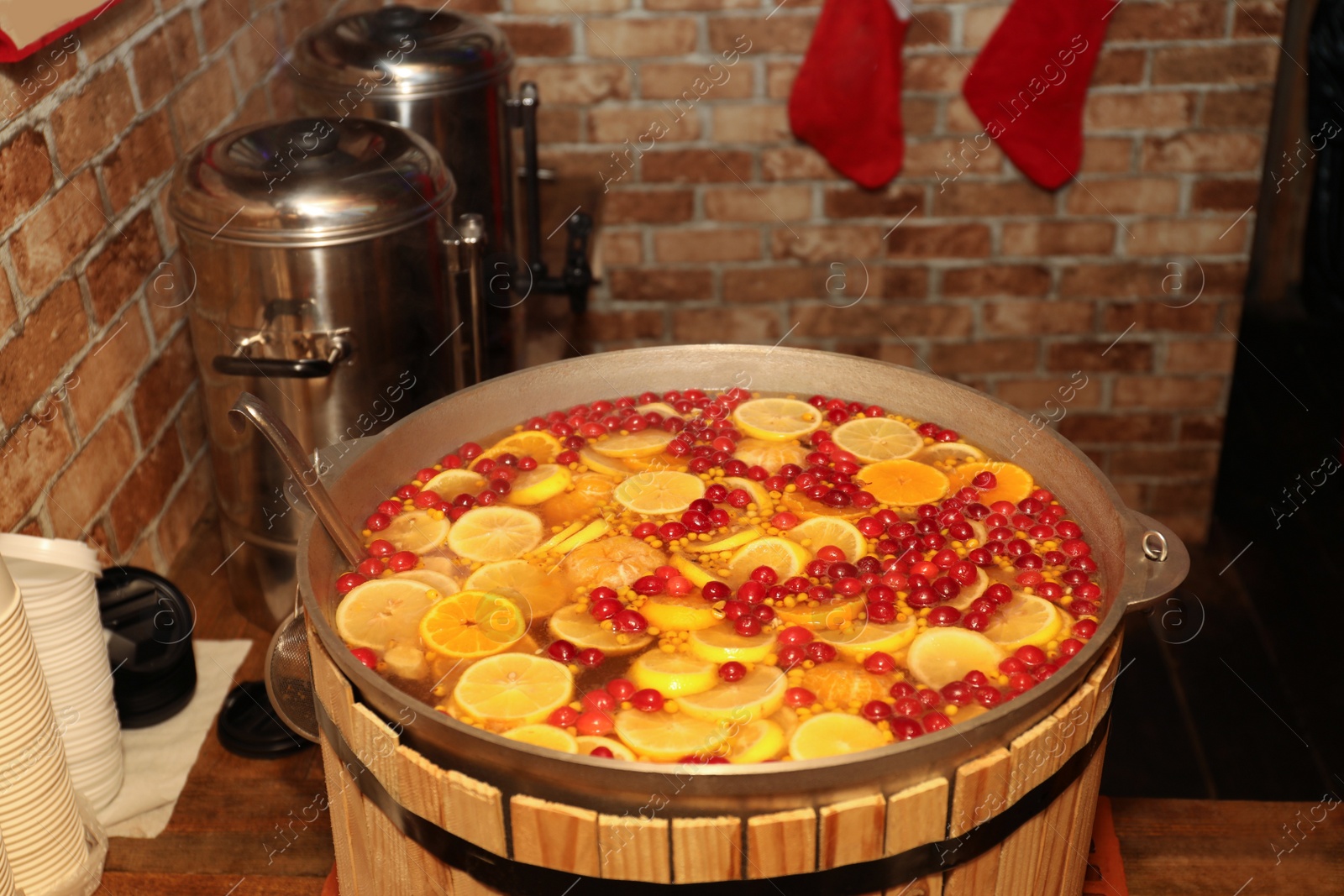 Photo of Large cauldron with tasty mulled wine at winter fair