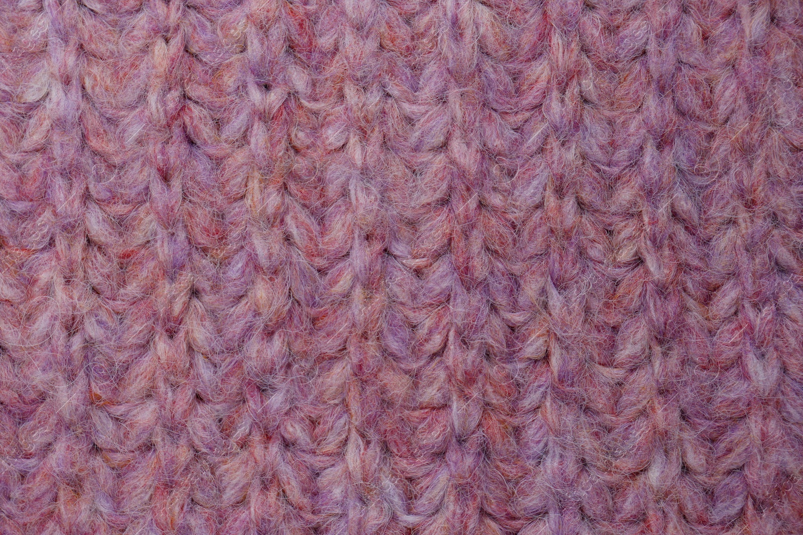Photo of Violet knitted fabric as background, top view