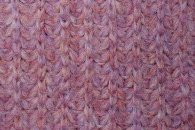 Violet knitted fabric as background, top view