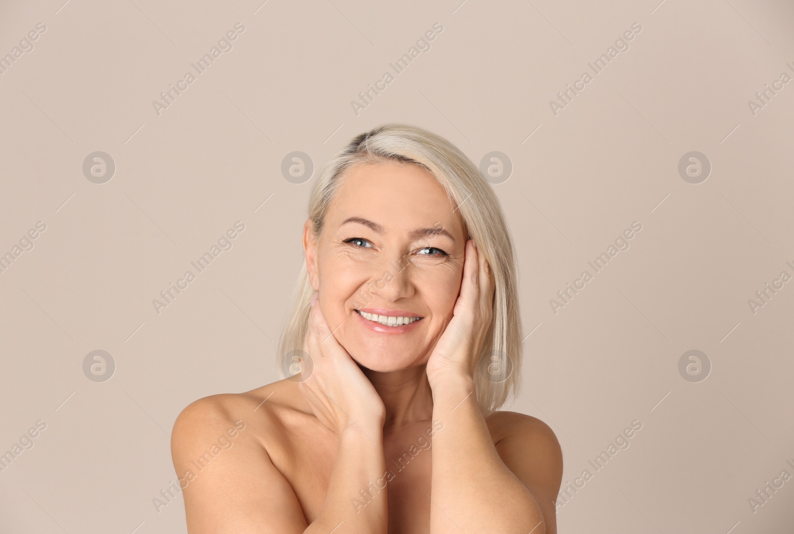 Photo of Portrait of beautiful mature woman on beige background