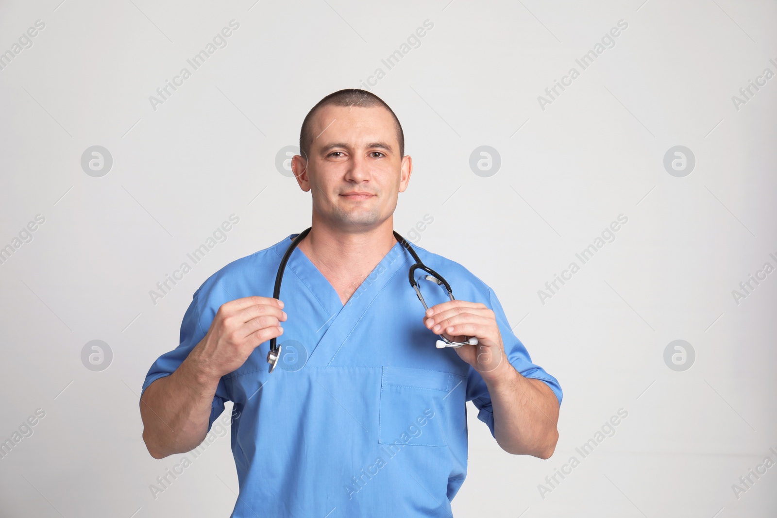 Photo of Portrait of medical assistant with stethoscope on color background