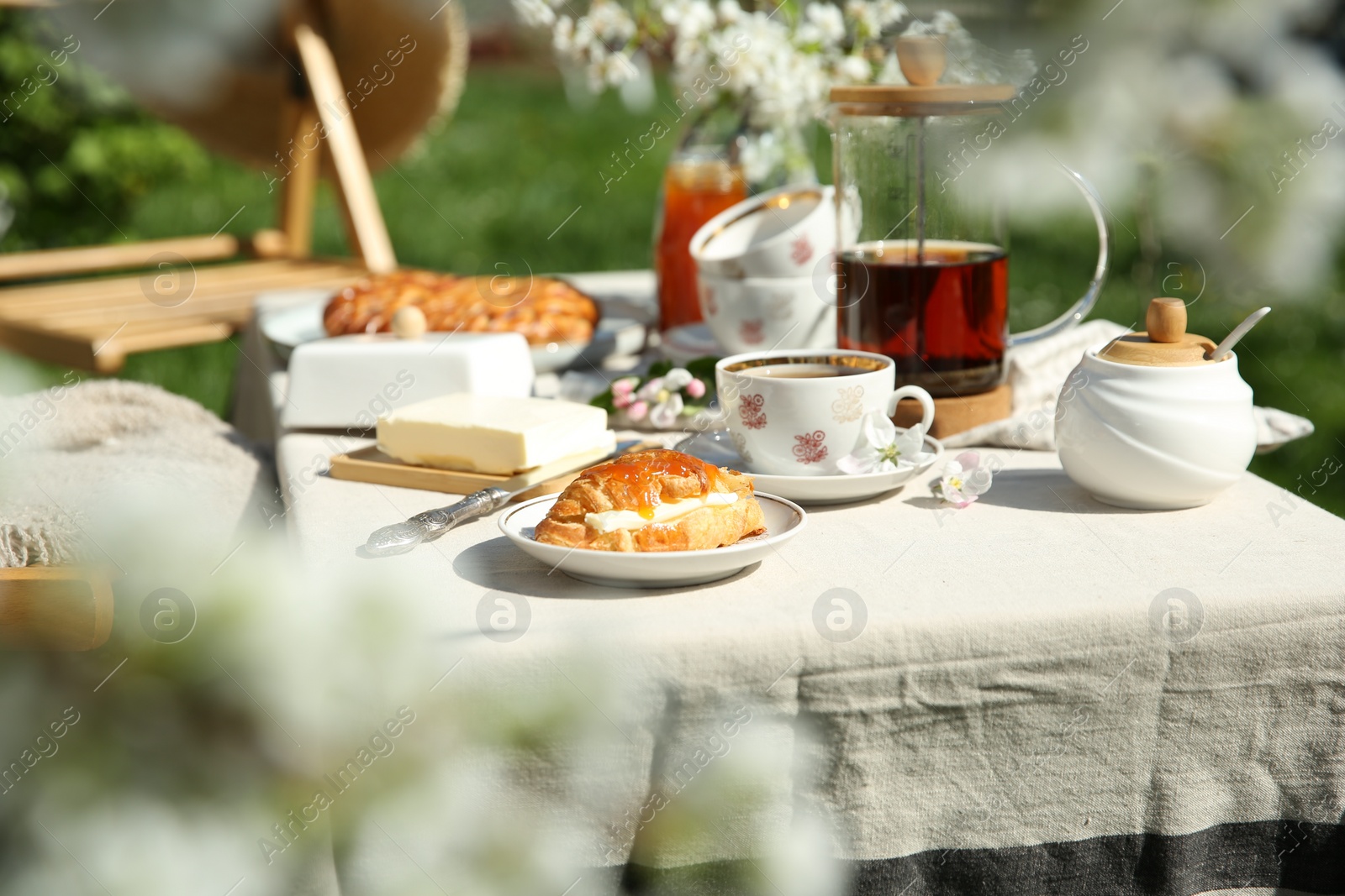 Photo of Beautiful table setting in spring garden on sunny day