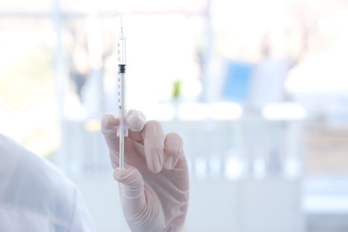 Female doctor with syringe in hospital. Vaccination day