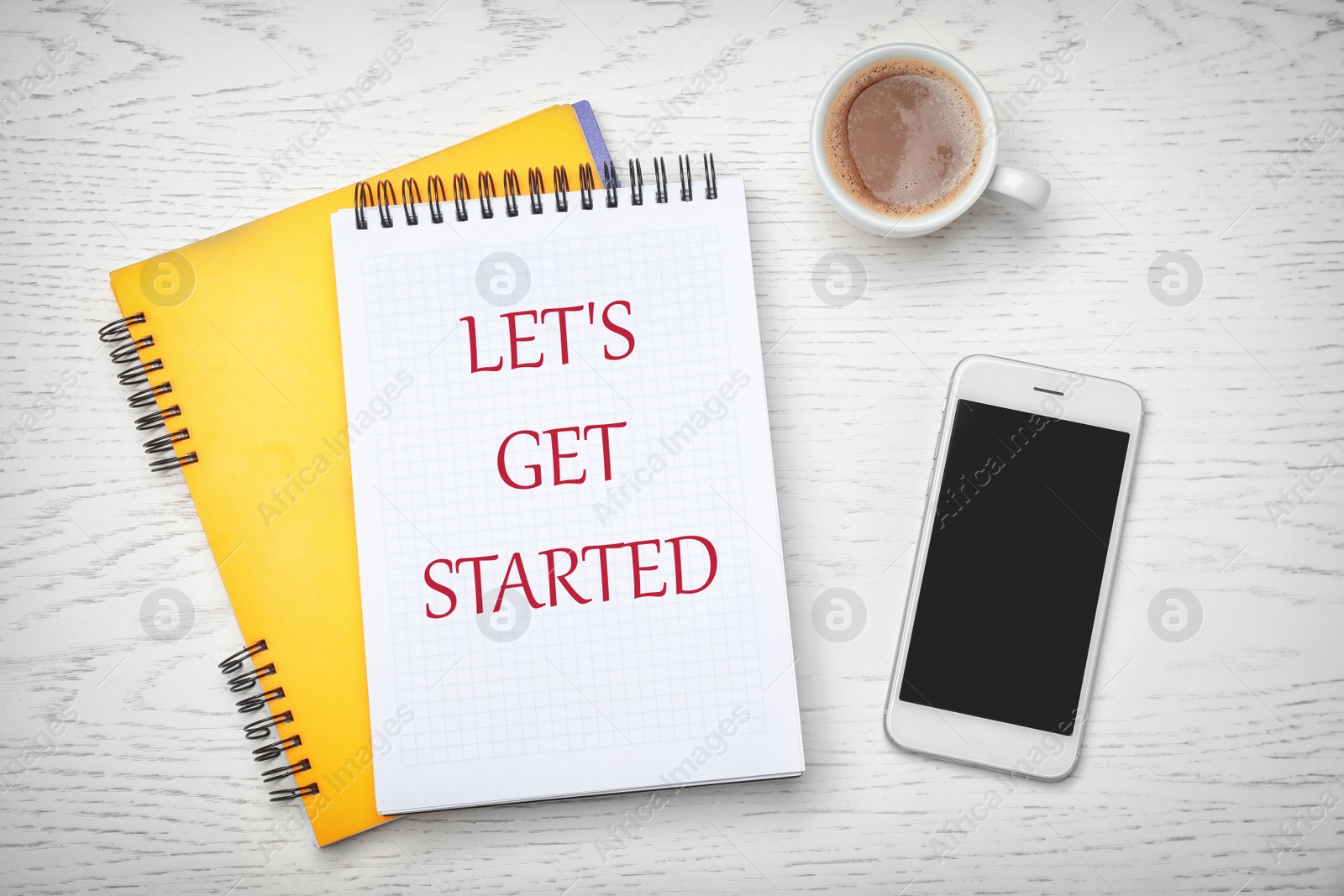 Image of Notebook with phrase LET'S GET STARTED, smartphone and cup of coffee on white wooden background, flat lay