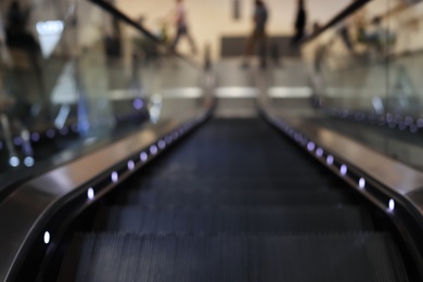 Photo of Blurred view of modern escalator in shopping mall