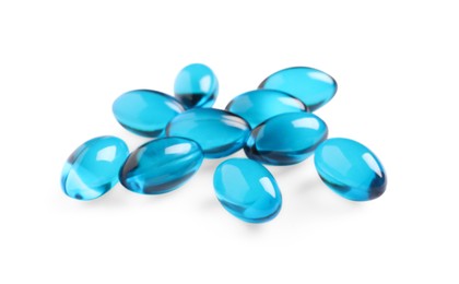 Photo of Many light blue pills isolated on white. Medicinal treatment