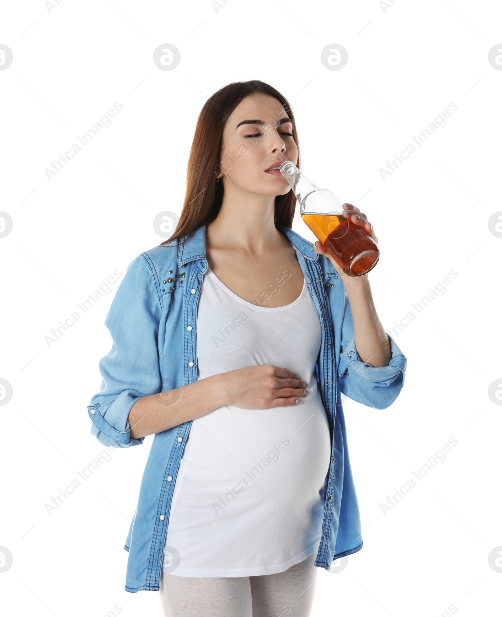 Photo of Future mother drinking alcohol from bottle on white background. Bad habits during pregnancy