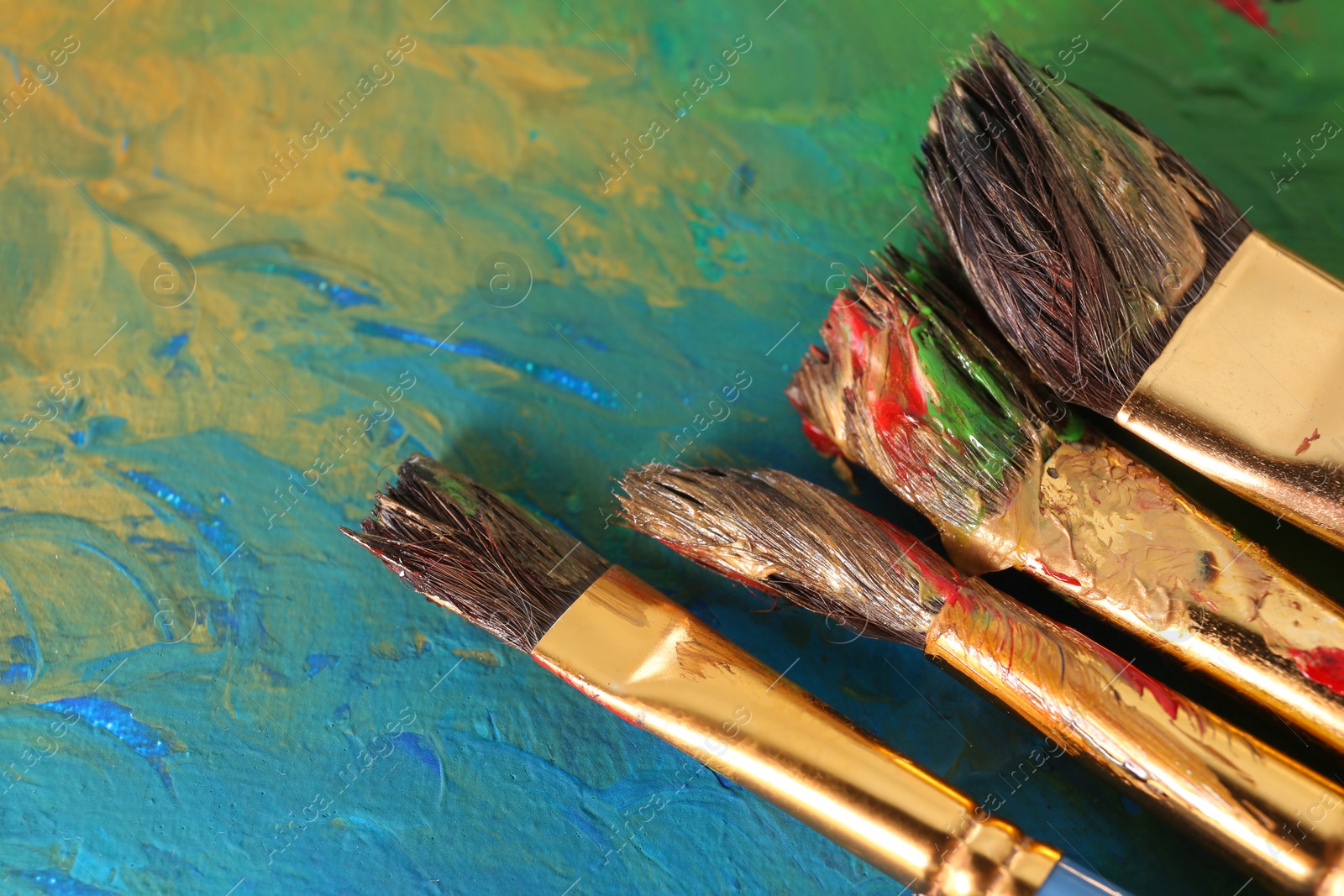 Photo of Abstract colorful artwork and brushes, closeup view