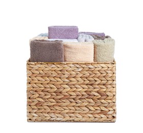 Photo of Wicker laundry basket with clean terry towels isolated on white