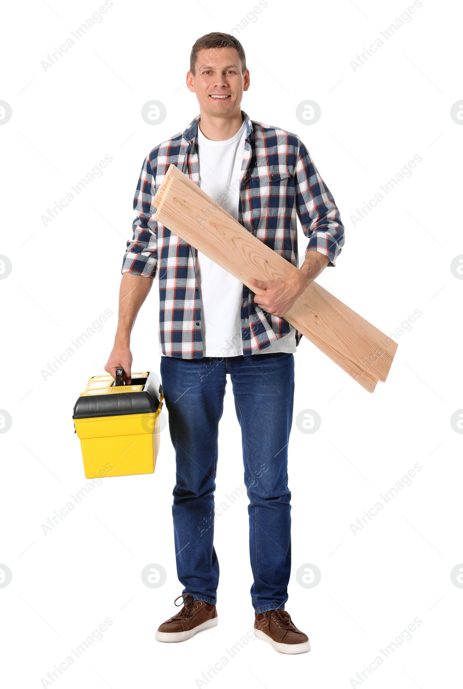 Photo of Handsome carpenter with wooden planks and tool box isolated on white