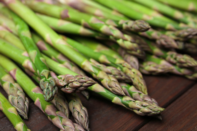 Fresh raw asparagus on wooden table, closeup