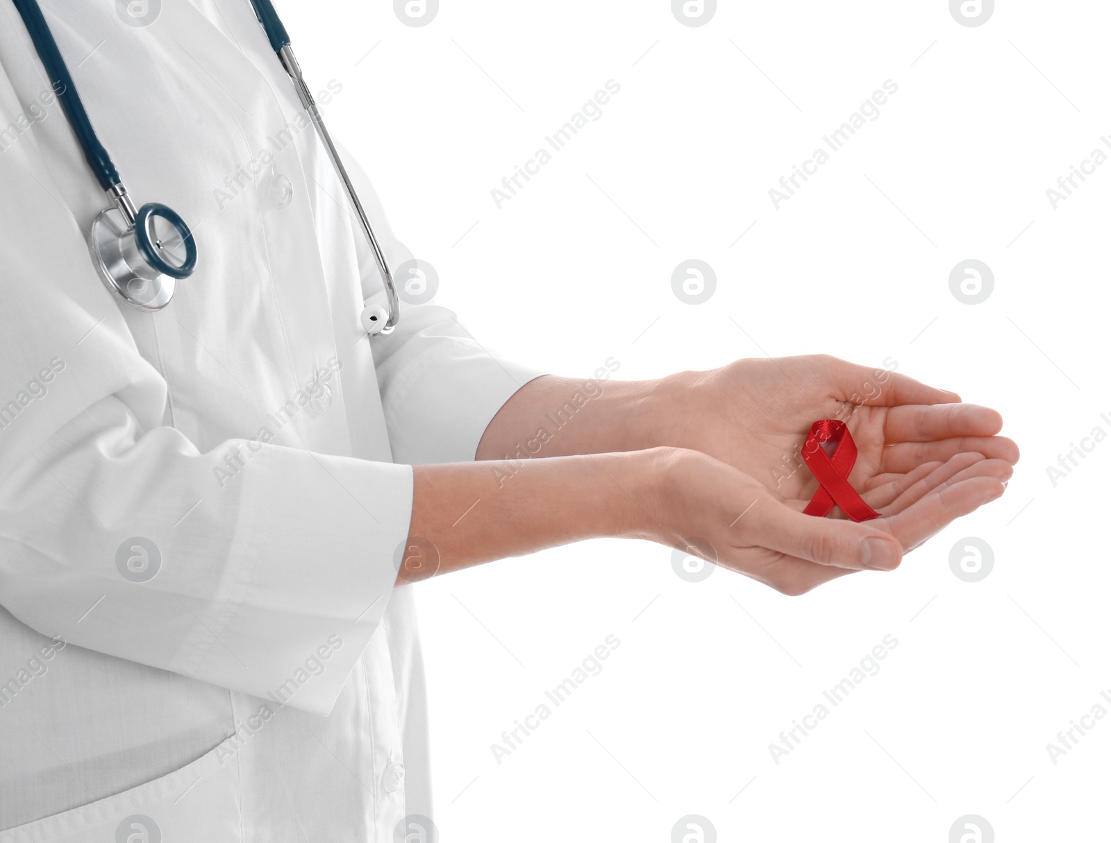 Photo of Doctor holding red awareness ribbon on white background, closeup. World AIDS disease day