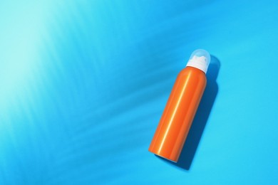 Photo of Sunscreen on light blue background, top view and space for text. Sun protection care
